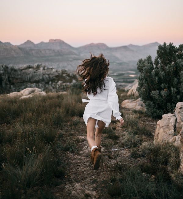 Person looking serene and energized after a movement session, outdoors.
